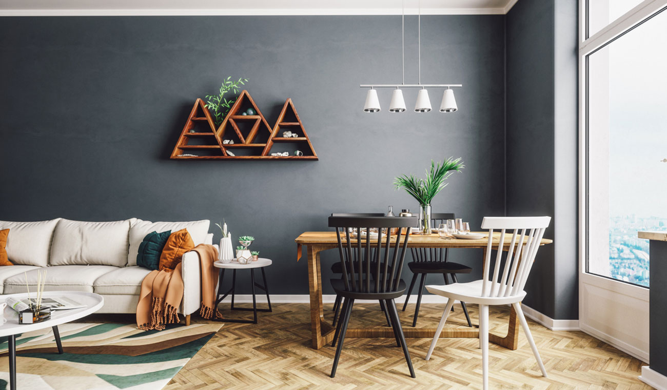 Scandinavian-style short term rental property with mismatched chairs, a gray accent wall, and a big white sofa